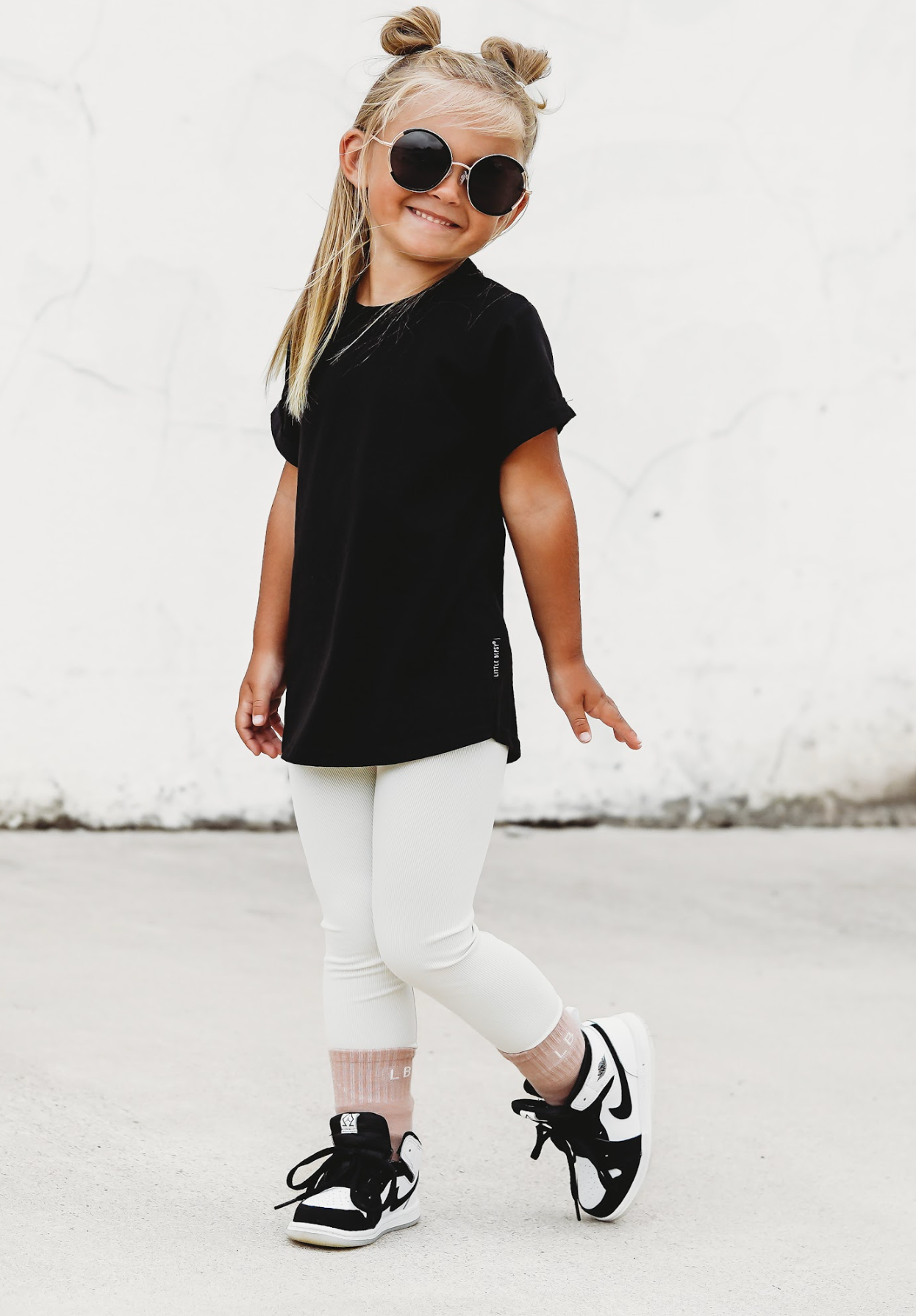 Little girl in kids basic tee and kids leggings and kids trendy socks