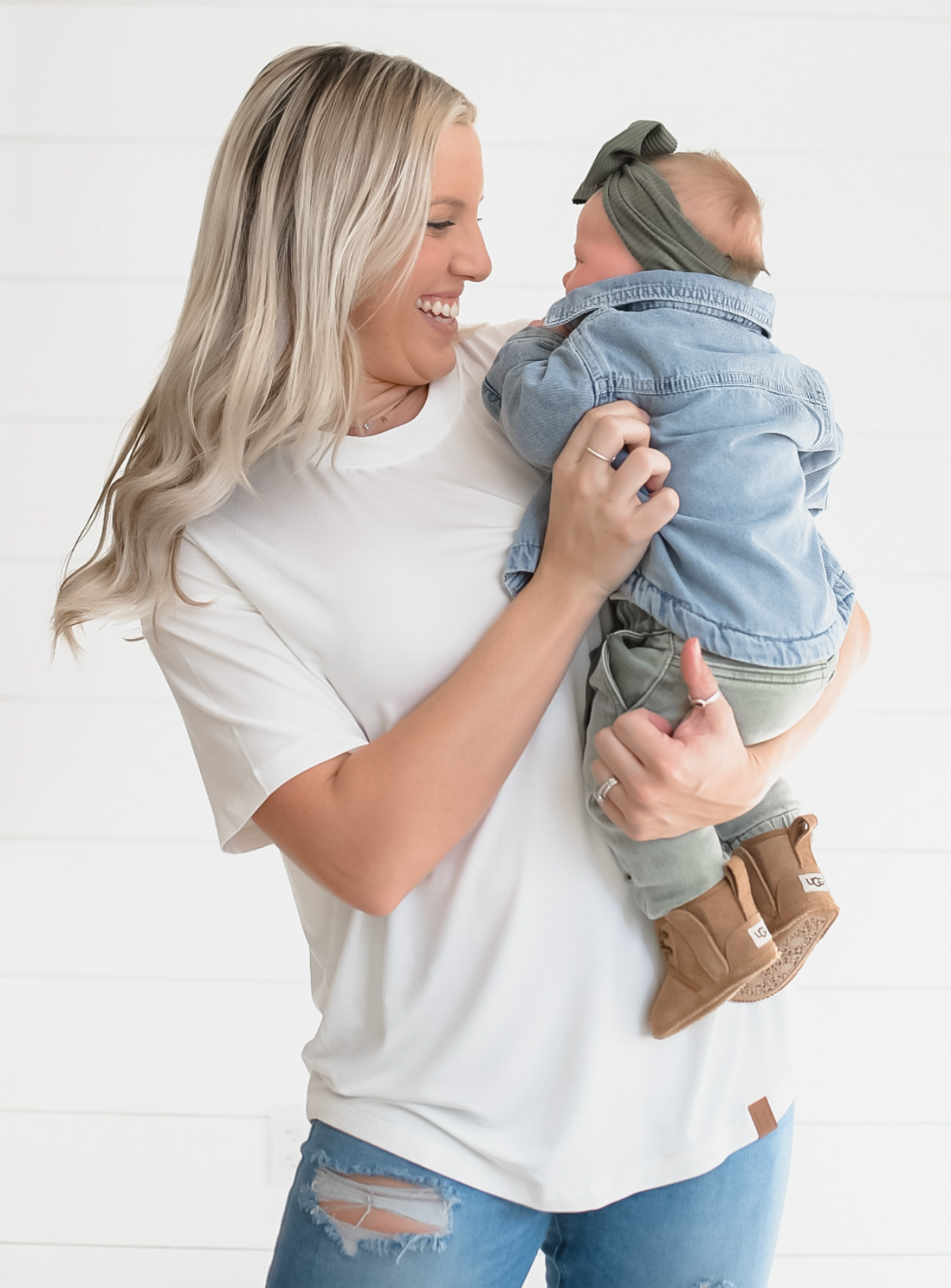 Woman in white, bamboo tee holding baby