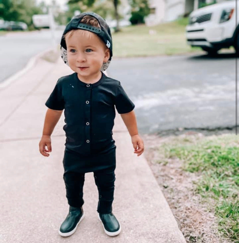 Toddler in black romper